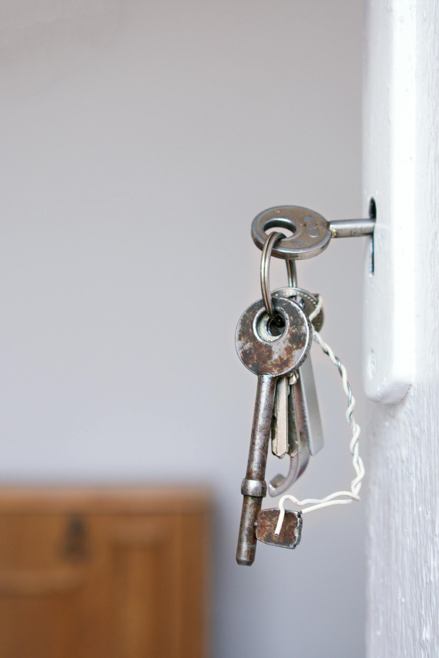 Louisville Locksmith technician rekeying commercial door lock for local business